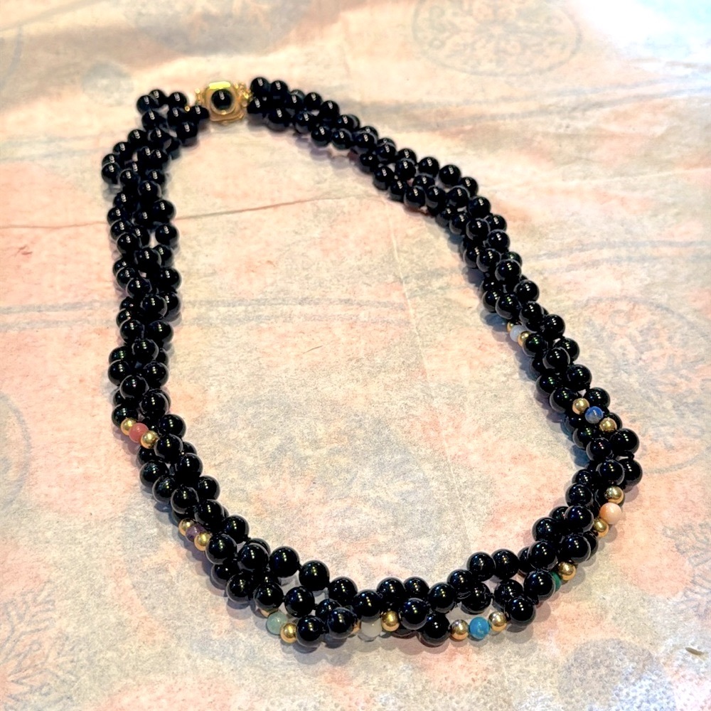 Triple-strand black onyx beads w/multicolored bead accents & 14k gold clasp 18”